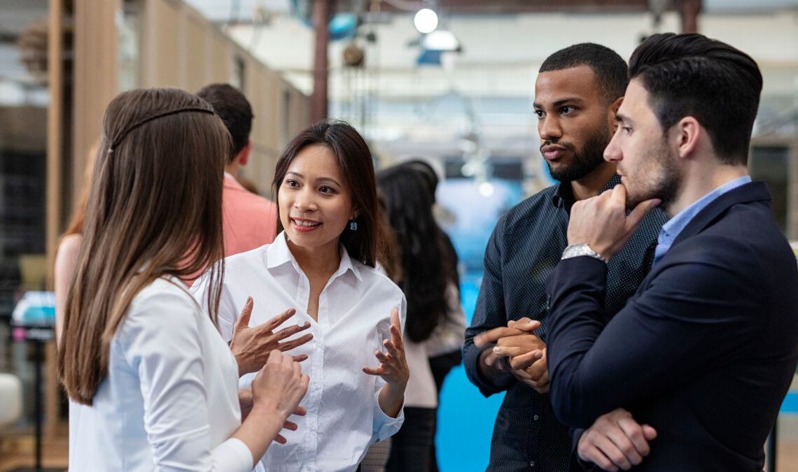 A group of professionals networking at a tech industry event.